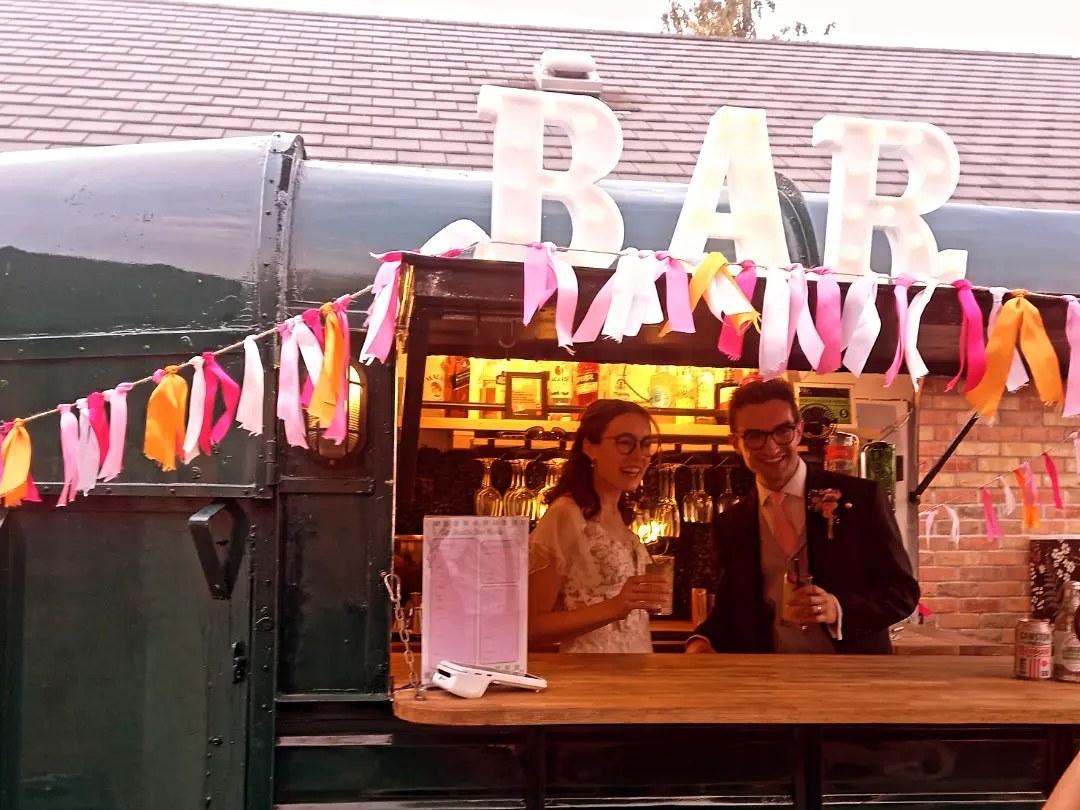 Guests celebrating with cocktails at Sip Shuttle Bar